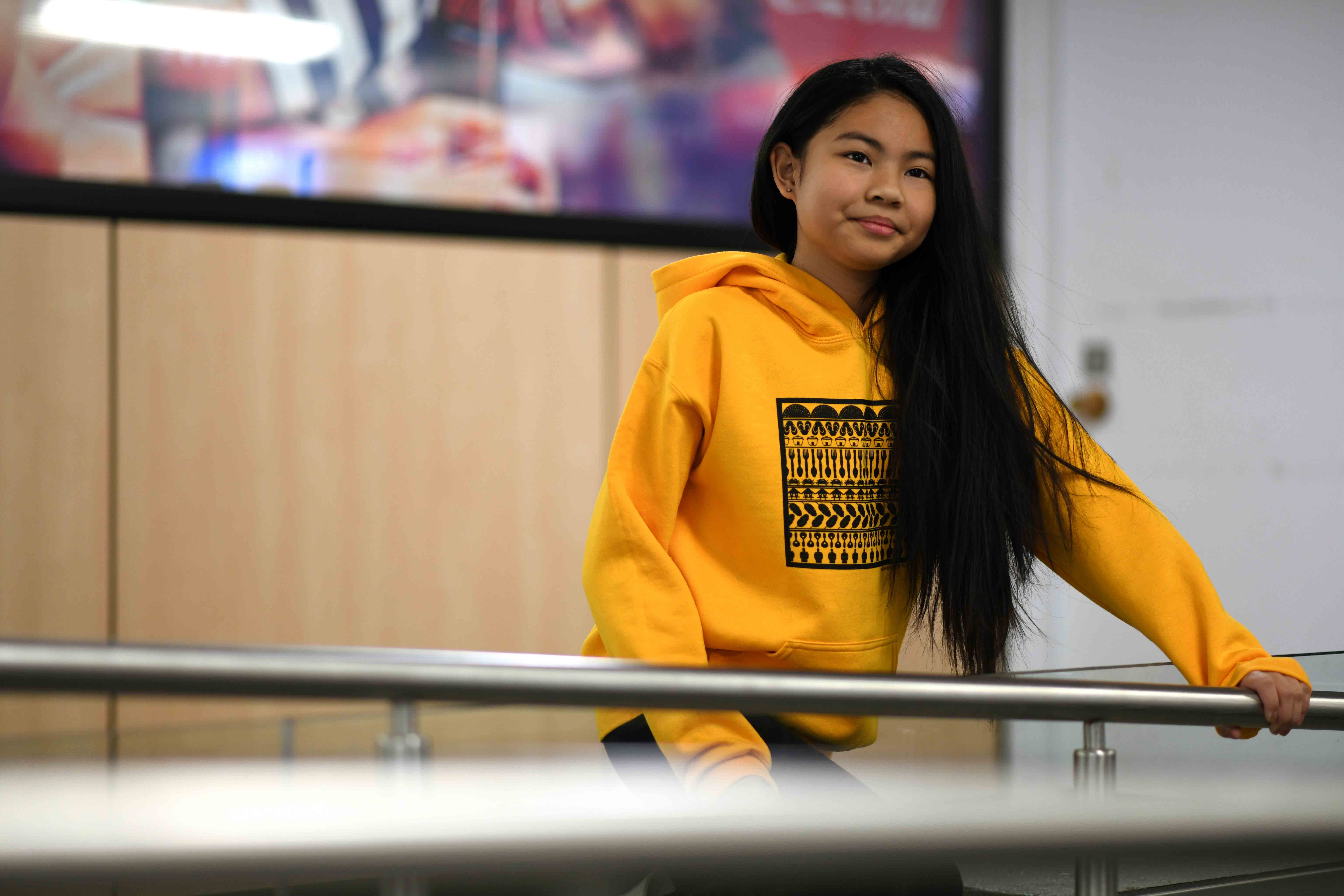 Yasmin modelling our Modern Island Youth Hoodie (gold colour) at the University of Manitoba