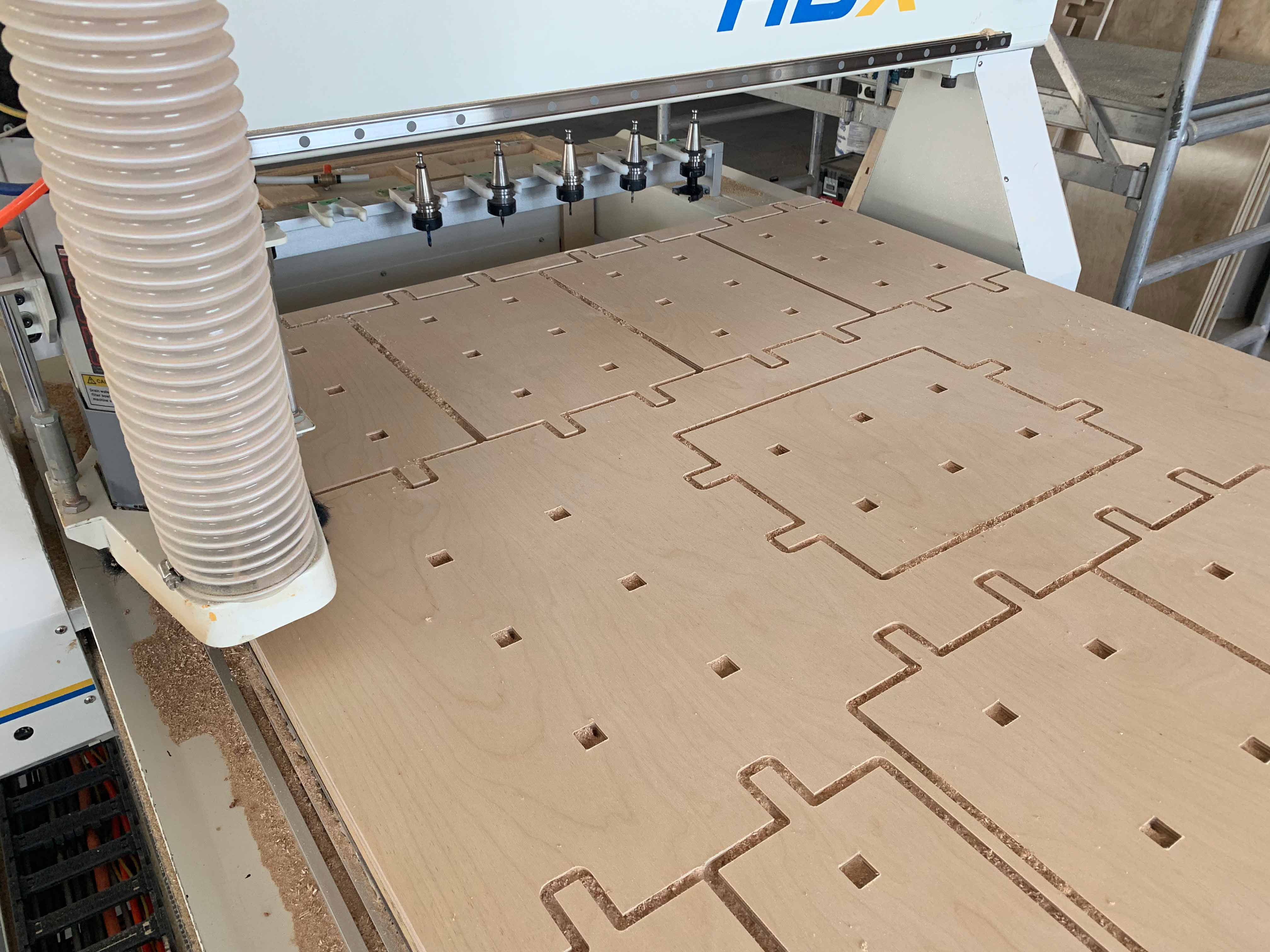 Wood panels being cut on the CNC machine