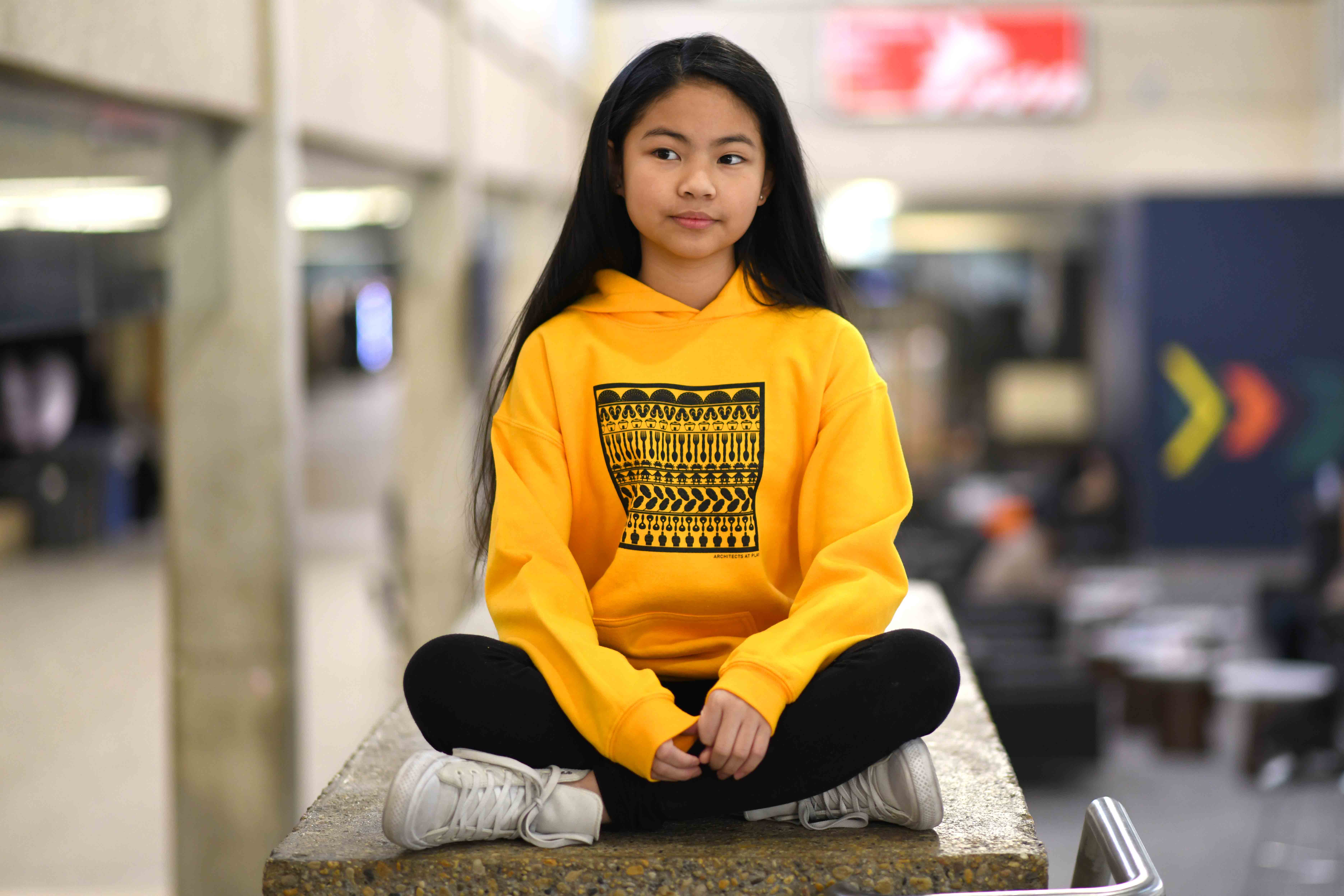 Yasmin modelling the Modern Island Youth Hoodie at the University of Manitoba