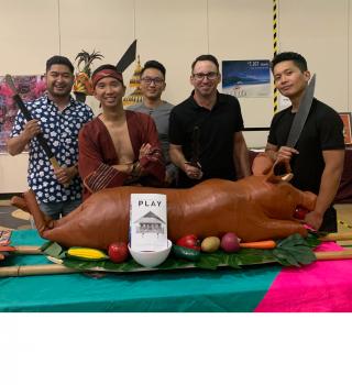 Play posing with the lechon prop